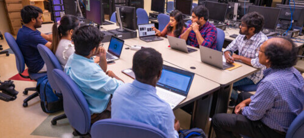 Students meeting with Dr. Shan Suthaharan